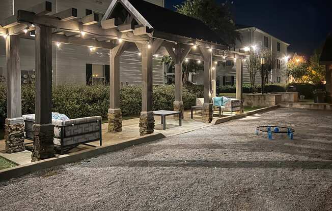 a patio with benches and lights on a house at night at Avalon Apartment Homes, Starkville, MS, 39759