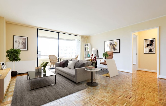 A living room with a grey sofa and a glass coffee table.