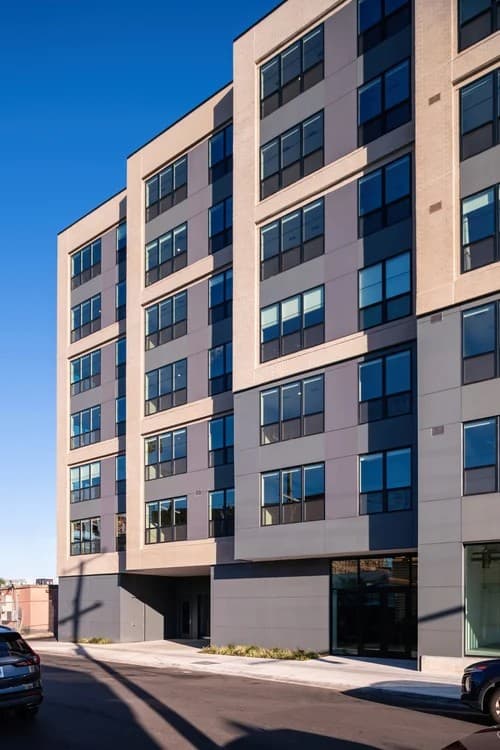 A modern building with a clear blue sky in the background.