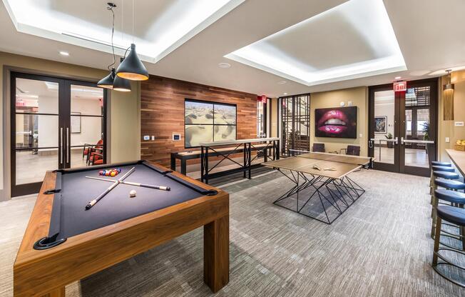 Game room featuring billiards and shuffleboard for relaxed recreation.