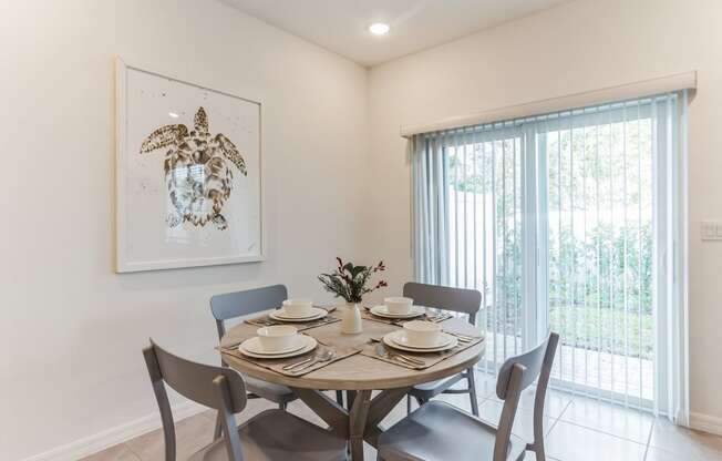 Boatman Hammock Townhomes in Lake Worth, FL photo of a dining room with a table and chairs and a window