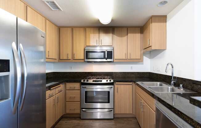 a kitchen with stainless steel appliances and wooden cabinets