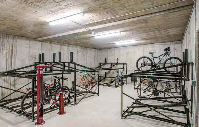 A bike shop with bikes on stands and a red fire extinguisher.