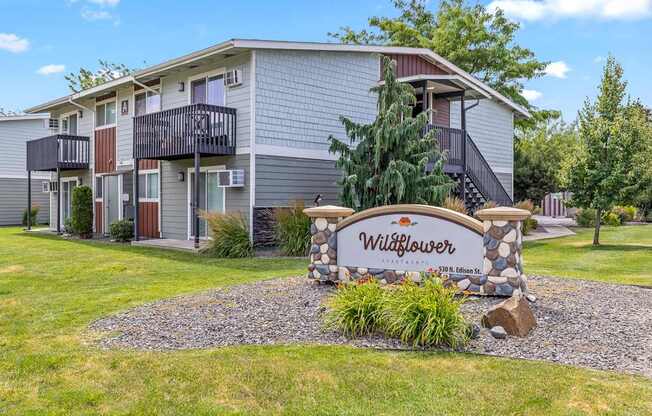 A sign in front of a building that says Wildflower at Wildflower, Kennewick, WA 99336.