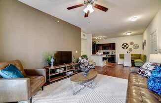 a living room with a ceiling fan and hardwood flooring