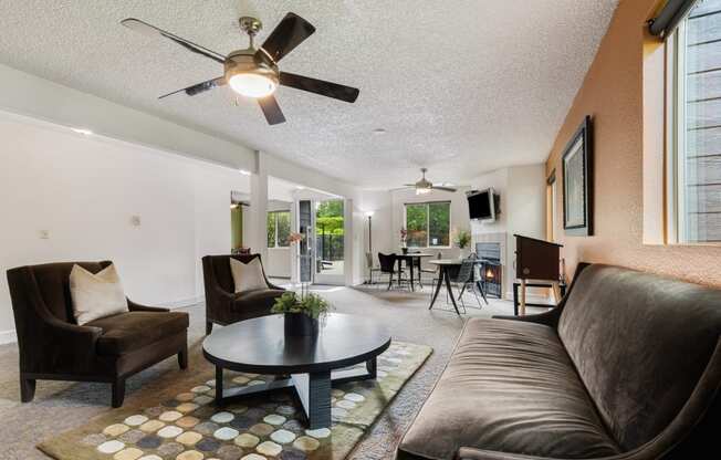 a living room with couches and chairs and a table at Eagles Landing Apartments, Everett, 98204