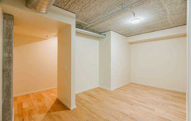 A room with wooden floors and a ceiling with a light fixture.