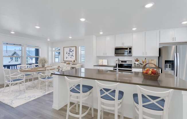 a large kitchen with a breakfast bar and a dining area