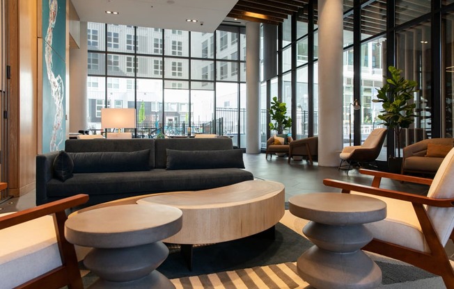 the lobby of a hotel with couches and tables
