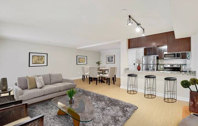 a living room with a couch and a table with stools