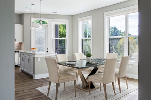 a dining room and kitchen with a table and chairs