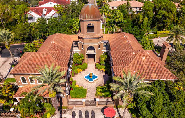 Aerial of clubhouse courtyard with fountain and surrounding palm trees