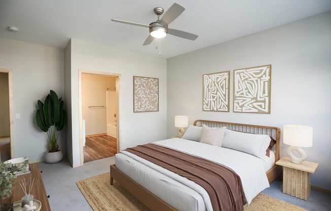 a bedroom with a large bed and a ceiling fan