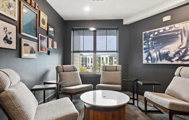 A living room with grey chairs and a coffee table.