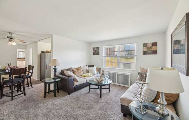 A living room with a couch, chairs, and a coffee table.