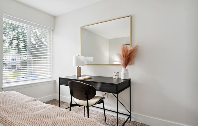 a bedroom with a bed and a desk with a mirror at Linkhorn Bay Apartments, Virginia, 23451