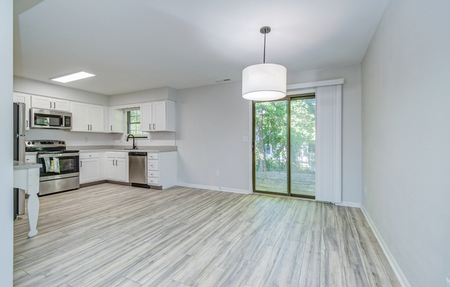 Glass patio door and kitchen interior at The Arbor in Blue Springs, MO