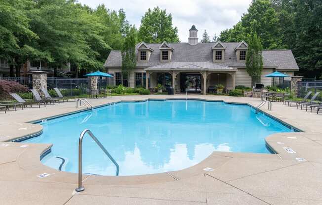 a resort style pool with a house in the background