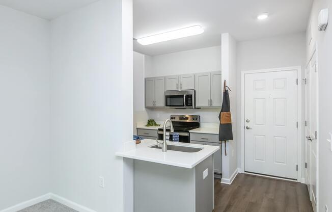 a kitchen with a sink and a mirror