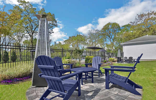A blue chair set sits in a yard.