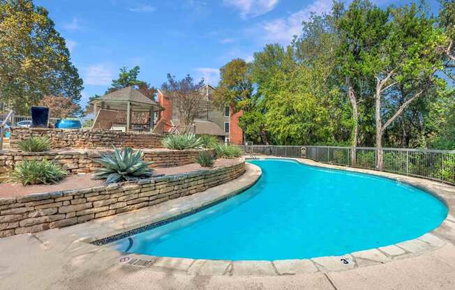 Pool surrounded trees at Great Hills, Austin Texas