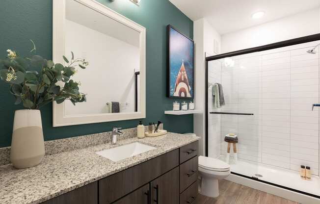 a bathroom with a toilet sink and shower with a glass door in Concorde apartment