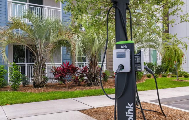 an electric charger on a pole in front of a building
