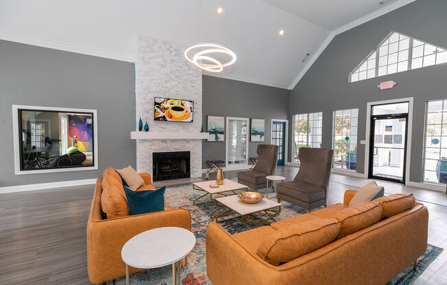 a living room with couches and chairs and a fireplace