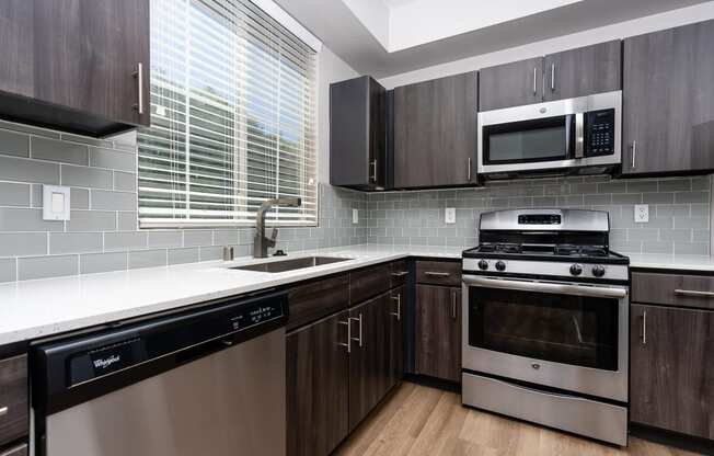 Apartments Spring Valley - Alicante - Kitchen with Stainless-Steel Appliances, Cabinets, Build-In Microwave and Wood-Style Floors