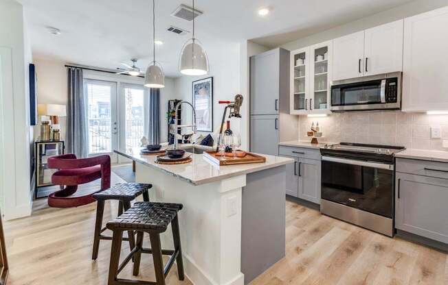A modern kitchen with a bar stool and a countertop.