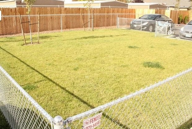 a fenced in yard with a no trespassing sign on the fence