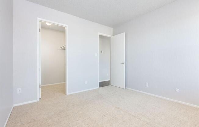 an empty living room with white walls and a closet  at Skyline Heights LLC, Daly City