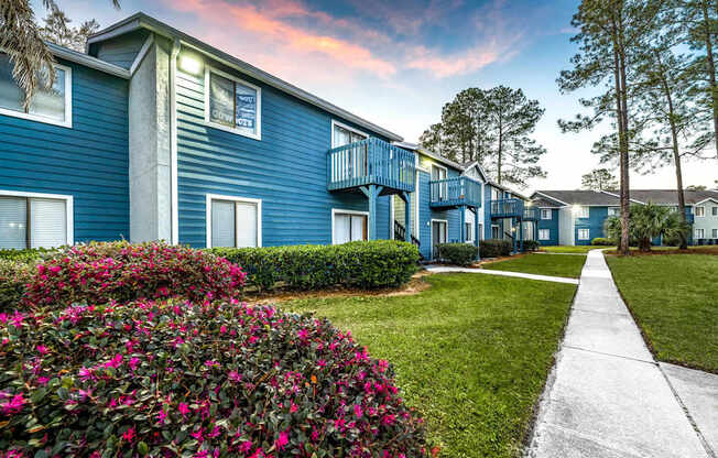 A blue building with a white walkway in front.