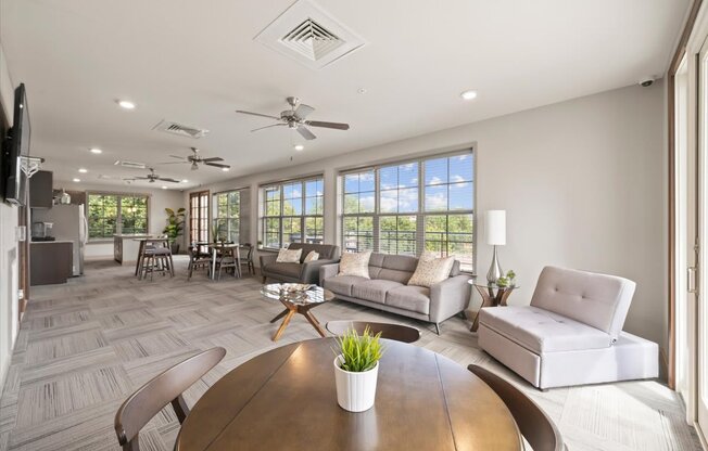 A modern living room with a wooden table and white furniture.