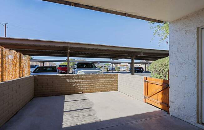 A parking lot is visible through a gap in a fence.