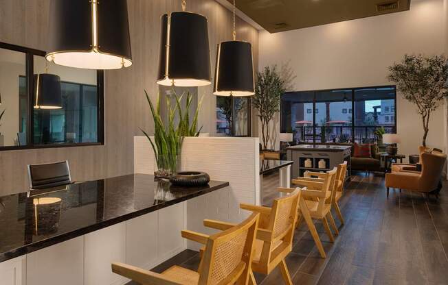 a kitchen and dining room with wooden chairs and a tableat Weylyn Luxury Apartments, Arizona