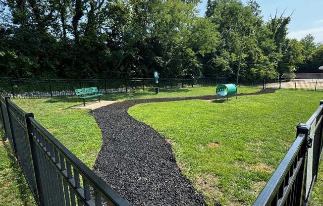 a path in a park with a fence