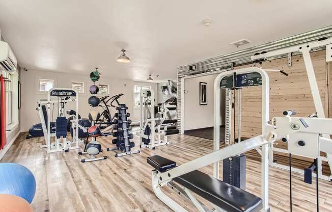 Fairview Apartments for Rent-Lodges at Lake Salish-Fitness Center with Equipment, Hardwood Style Flooring, Large Windows, and Overhead Lighting