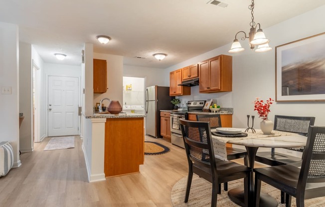 an open kitchen and dining room with a table and chairs