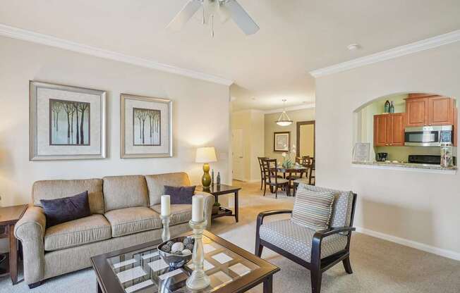 A living room with a couch, chair, and coffee table.