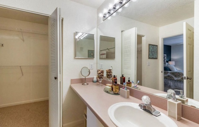 Bathroom with vanity lights and en-suite walk in closet