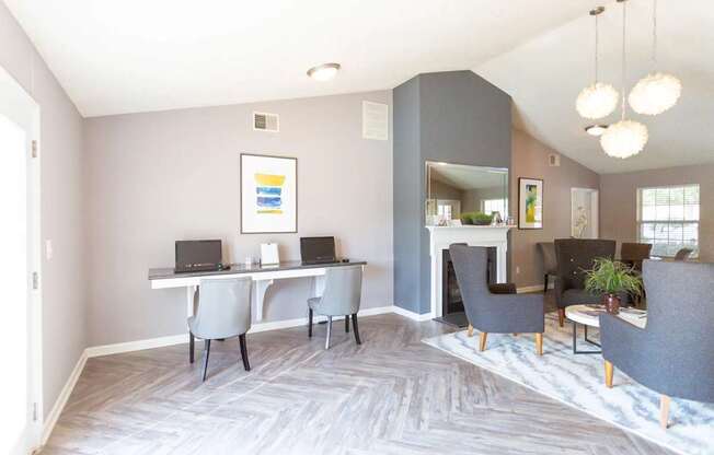 A room with a grey carpet and a grey sofa.