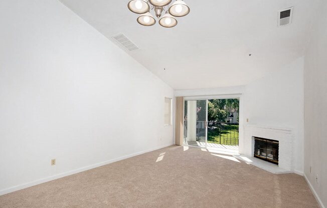 Living Room with High Ceilings, Brick Fireplace, and Private Patio Access at Laurel Creek, Fairfield, 94533