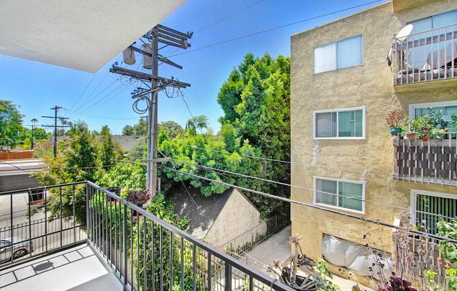 the view from the balcony of an apartment building with a balcony and a balcony railing