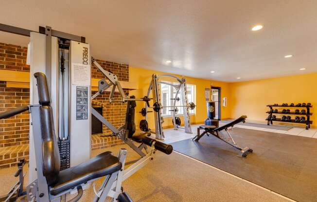 Workout area at Olde English Village, showcasing a clean space with cardio and strength-training equipment.