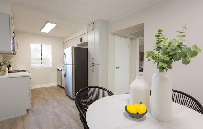 a kitchen and dining room with a table and a refrigerator