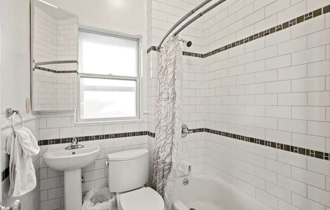 a small white bathroom with a toilet sink and tub