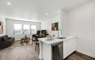 A modern kitchen with a dining table and chairs.