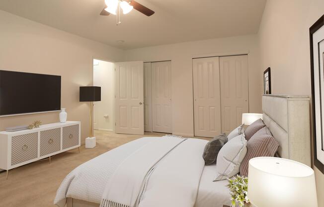 a bedroom with a bed and desk in a room