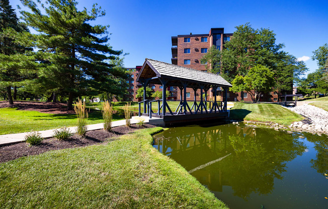 The Bennington Apartments property with a covered bridge over a small body of water